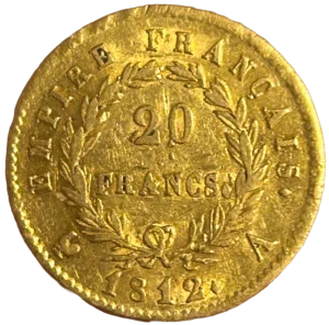L'inscription 20 FRANCS dans une couronne formée de deux branches de laurier.