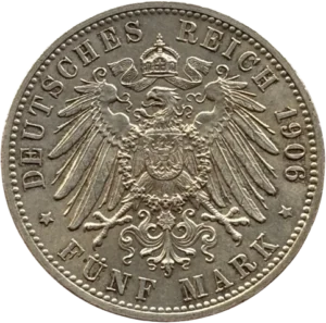 Aigle couronné et aux ailes déployées ayant en son centre les armoiries.