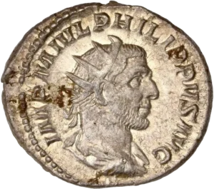 Buste radié et drapé de Philippe Ier à droite.