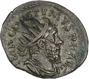 Buste radié, drapé et cuirassé de Postume à droite.