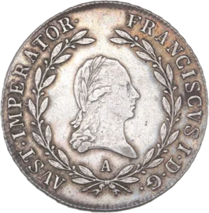 Buste lauré de François Ier à droite dans une couronne végétale.