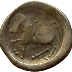 Restes de la tête laurée de Zeus à droite, fortement stylisée.