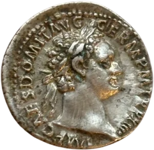 Tête laurée de Domitien à droite.