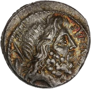 Tête barbue de Saturne à droite ; derrière, tête de harpon et pierre conique.