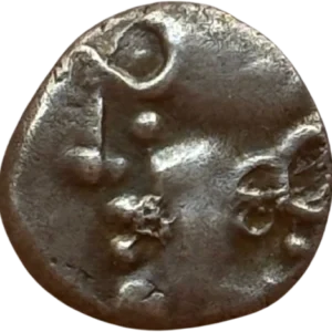 Tête casquée à gauche.