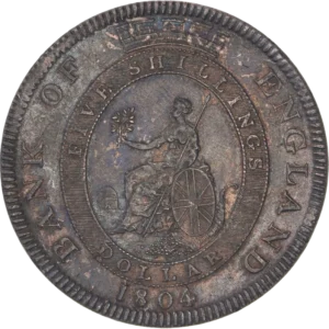 Au centre dans un médaillon surmonté d'une couronne légendée, Britannia assise à gauche sur un rocher, appuyée sur l'Union Jack, tenant une branche d'olivier et un sceptre. Le bouclier est posé sur une corne d'abondance déversant des pièces de monnaie.