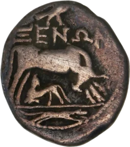 Vache à droite, allaitant un veau agenouillé à gauche ; dans le champ à gauche, un épi de blé ; à droite, une torche; au-dessus, les chapeaux des Dioscures.