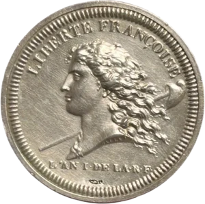 Buste de la Liberté à gauche au-devant d’une pique surmontée d’un bonnet phrygien.