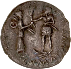 Hispania tenant deux javelines et un petit bouclier, présentant une palme à Cneius Pompée, vêtu militairement, tenant un glaive, le pied posé sur une proue de navire.