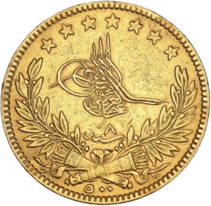 Toughra, accostée à droite au-dessus d'une couronne avec deux carquois entrecroisés.